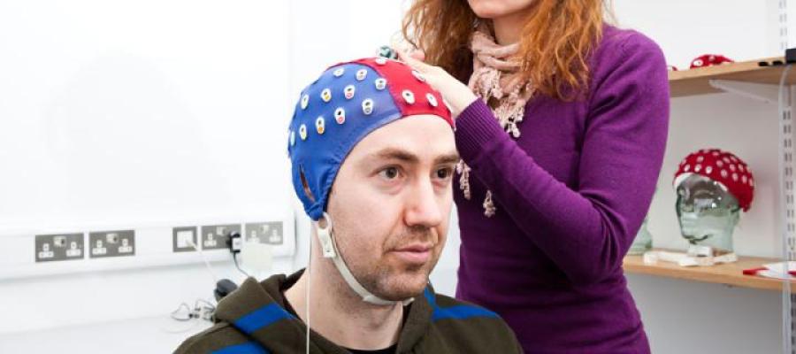 Picture of neuroscience lab with man getting head checked