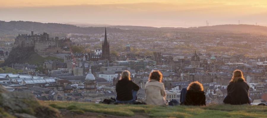 Students sitting looking out over Edinburgh from Salisbury Crags