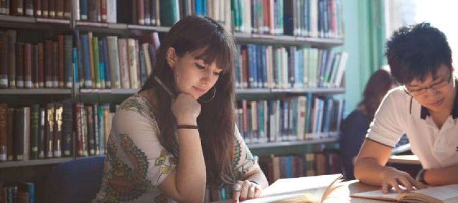 Female student in library with another student