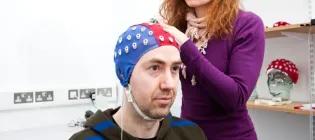Picture of neuroscience lab with man getting head checked