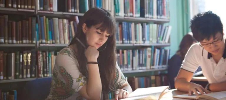 Female student in library with another student