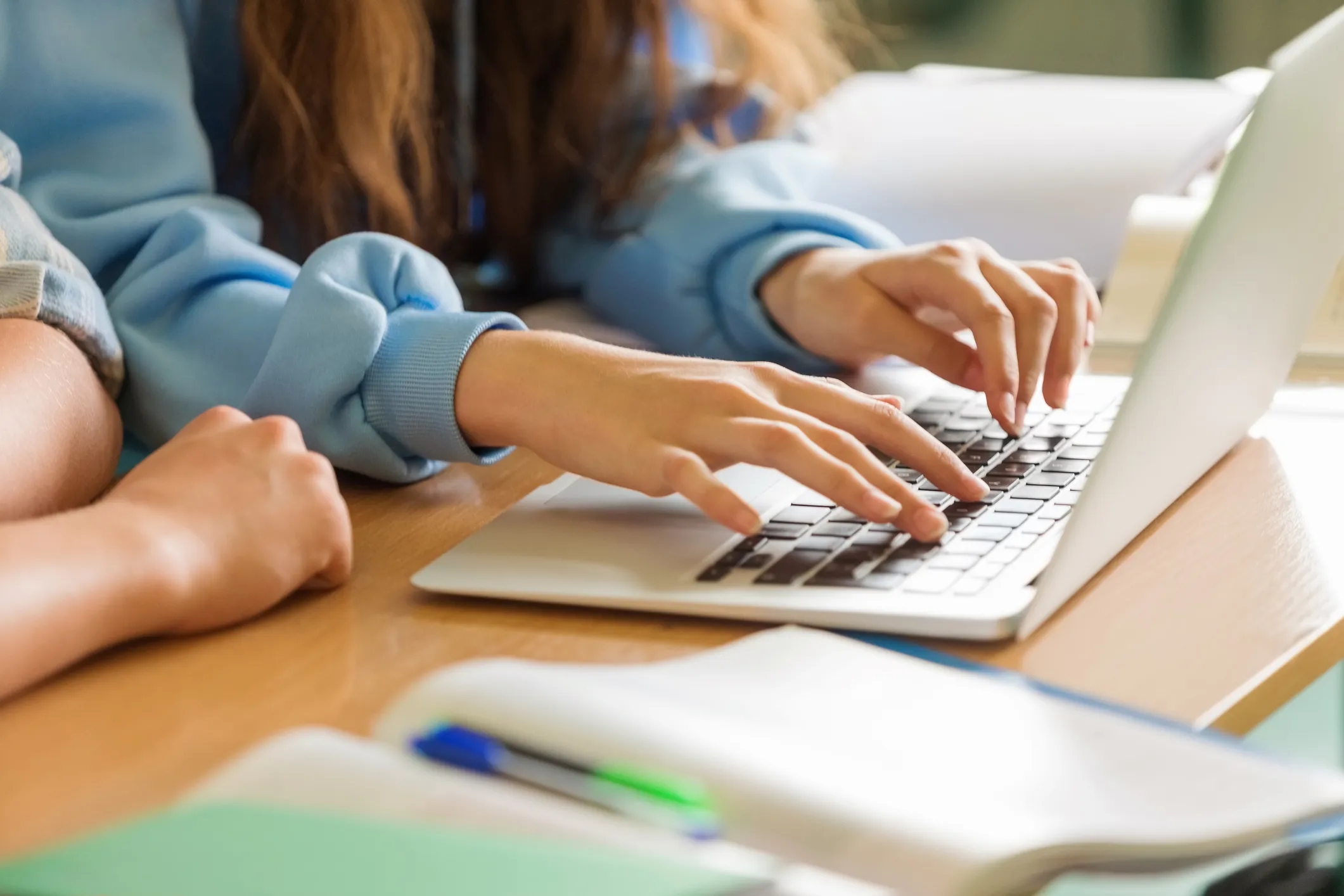 School pupils typing on a keyboard